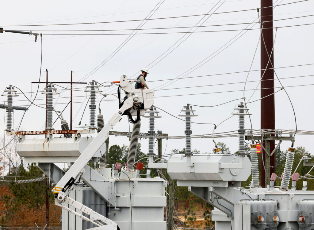 FILE PHOTO: Duke Energy personnel work to restore power at a second crippled electrical substation after the Moore County Sheriff said that vandalism caused a mass power outage, in Carthage, North Carolina, U.S. December 4, 2022.  REUTERS/Jonathan Drake/File Photo